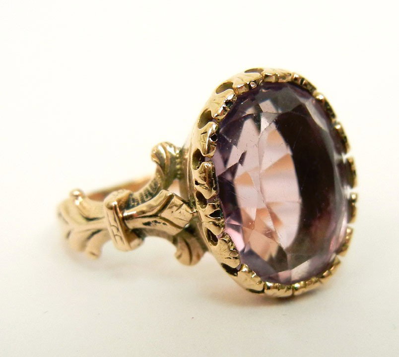 Victorian 14K gold and amethyst ring, light colore: Victorian 14K gold and amethyst ring, light colored oval shaped amethyst measures 13mm long x 10mm wide, stone is set in a fish tail prong-bezel "crown", fancy gold work on sides of band, size 6, unma