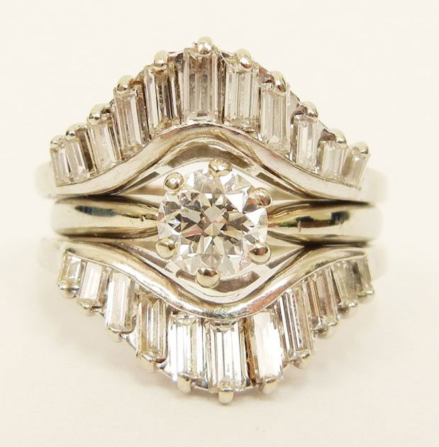 White gold diamond solitaire engagement ring with: White gold diamond solitaire engagement ring with diamond drop-in, center stone is a round old European cut diamond set into a six prong tall box on a pinched shoulder shank, clarity VS2, color I, car