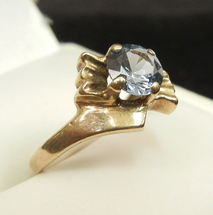 Gold blue zircon ring, crossover motif, single rou: Gold blue zircon ring, crossover motif, single round blue zircon in four prong 10K yellow gold mounting, stone measures 5mm in diameter, size 4, marked 10K, weight 1.6 grams/1.0 dwt, mid 20th C.