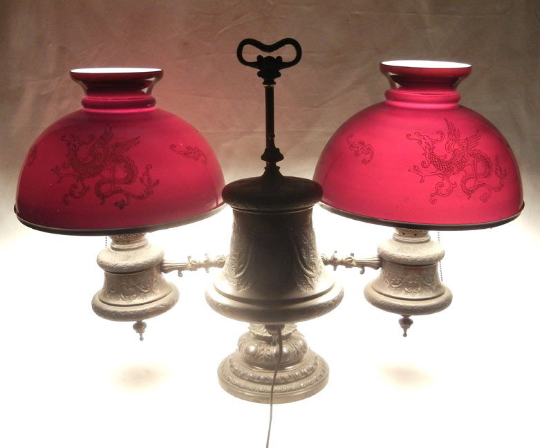 Spelter double student lamp, ruby red gilded drago: Spelter double student lamp, ruby red gilded dragon etched case glass shades, converted to electric, late 19th C., 21" high x 30