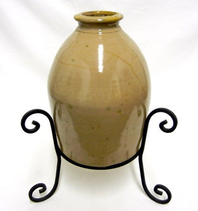 Stoneware crock on wrought iron stand: Glazed stoneware crock on wrought iron stand, large crackle glaze, crock measures 13 1/2" high, 19" high in stand