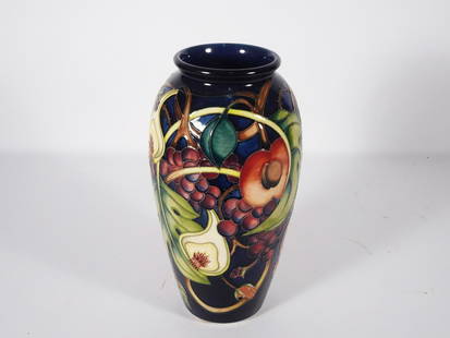 Moorcroft Pottery Queens Choice Vase: Moorcroft English art pottery Queens Choice pattern vase, cobalt blue ground with sculptured grapes, figs, peaches and leaf designs, signed on underside of base "Moorcroft 2000" with the artist initia