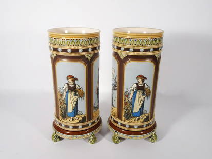 Pair of Mettlach German Pottery Vases: Pair of Mettlach German pottery #1462 vases, cylindrical form with panels depicting four maidens in relief representing the four seasons, applied scrolled feet, impressed marks on underside of base,