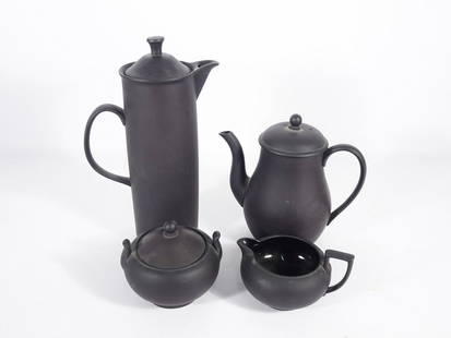 Wedgwood Basalt Black Tea Set: Four piece Wedgwood Basalt Black tea set, circa 1960's, each piece is marked on underside of base, 2 1/2" high 146 sugar bowl with lid, 2 3/8" high 146 shape creamer, 6 1/2" teapot with lid and 11