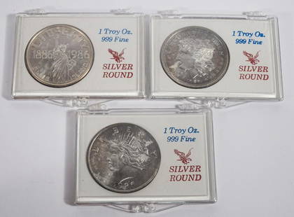 Three .999 Fine Silver Rounds: 1986 Morgan dollar replica, 1986 Peace dollar replica, and 1886 - 1986 Liberty Ellis Island