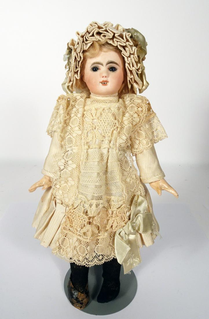 French Le Parisien bisque bebe by Jules Steiner: French Le Parisien bisque bebe by Jules Steiner, marked Le Parisien (red stamp) on head. 9 ½". Bisque socket head, blue paperweight eyes, painted lashes, feathered brows, pierced ears, open mouth wit