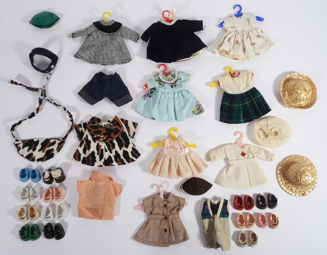 Vogue Ginny doll clothing assortment in wardrobe: Vogue Ginny doll clothing assortment in wardrobe, includes tagged Brownie outfit, tagged nurse dress with panties, tagged plaid jumper with belt, tagged pink lace dress with panties, many pairs of sho