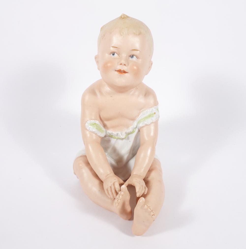 Antique Heubach figurine: Antique Heubach figurine, seated child piano baby, impressed mark on back, 8 1/2" high