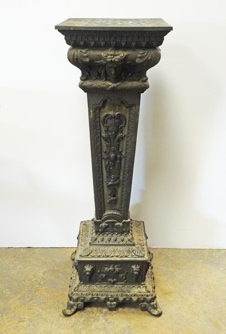 Victorian Cast Metal Pedestal Stand: Victorian cast metal pedestal stand, tapering square form with floral and geometrical pattern decoration featuring female and lion masque head motifs in relief, mid to late 19th c., 35 1/2" high x 13"