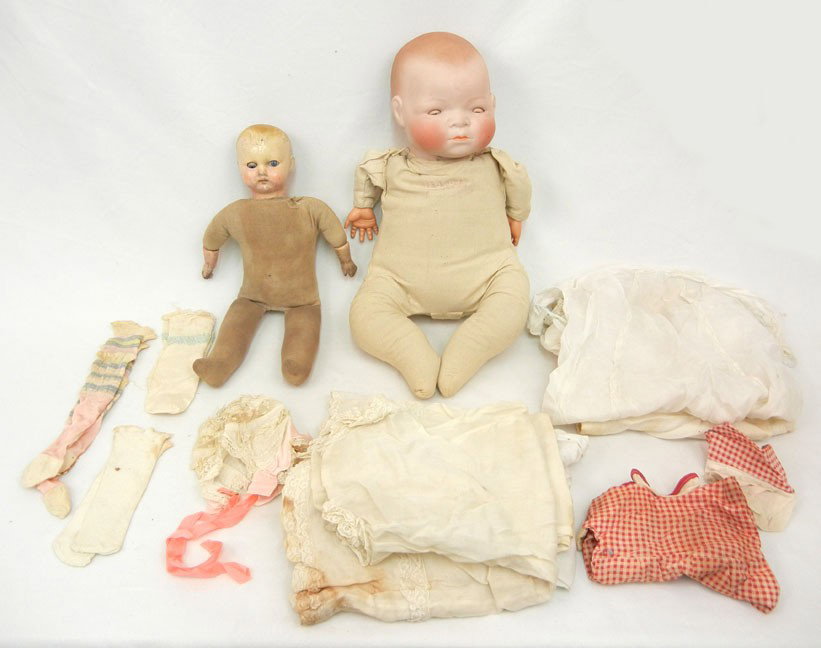 Grace S. Putnam Bye-lo baby doll, 17", stamped clot: Grace S. Putnam Bye-lo baby doll, 17", stamped cloth body, Ca. 1923; and an American composition doll with tin sleep eyes, cloth body, 13 3/4", Ca. 1930; and miscellaneous doll clothing