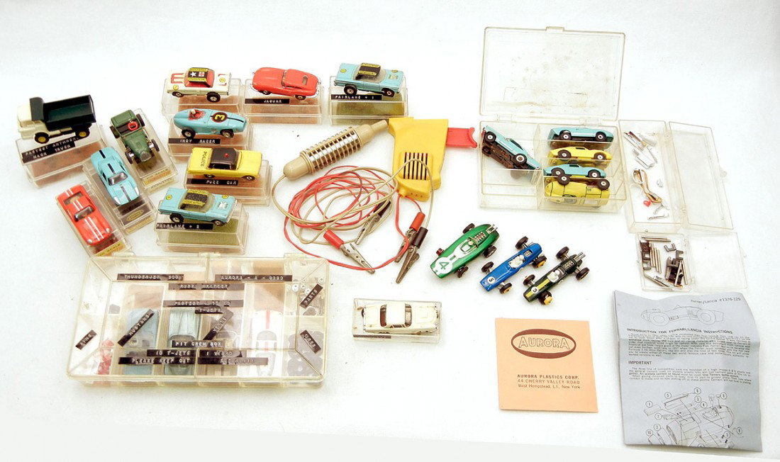 Grouping of twenty-one slot cars and car parts; an: Grouping of twenty-one slot cars and car parts; and two Matchbox series cars, including H.O. scale Aurora Ferrari, Porsche 906, Indianapolis racer, 1962 Ford police car, Hot Rod roadster, and some mar