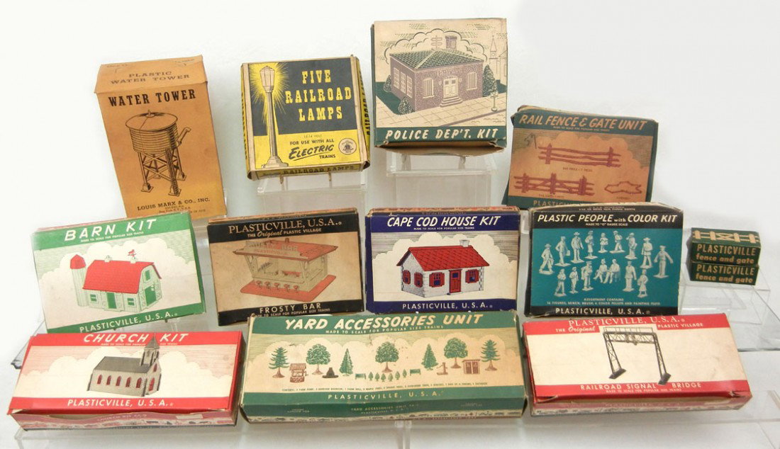 Grouping of Plasticville kits and platform pieces: Grouping of Plasticville kits and platform pieces including barn kit, Railroad signal bridge, yard accessories unit, rail fence and gate unit, Church kit, Frosty Bar, Cape Cod house kit, Police Dept k