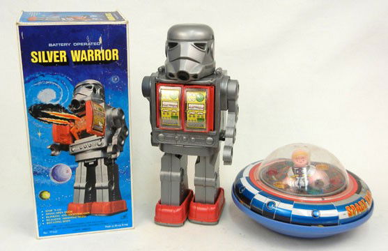 Two battery operated toys, Silver Warrior in origi: Two battery operated toys, Silver Warrior in original box, 11 3/4" high, and a X-5 space ship, 8" across
