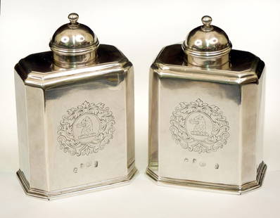 Pair of Britannia standard Queen Anne silver tea c: Pair of Britannia standard Queen Anne silver tea caddies, hallmarked Ash (Thomas Ash) London, domical lids with balaster finial, sliding base, front and back engraved with large heraldic emblems, ca.