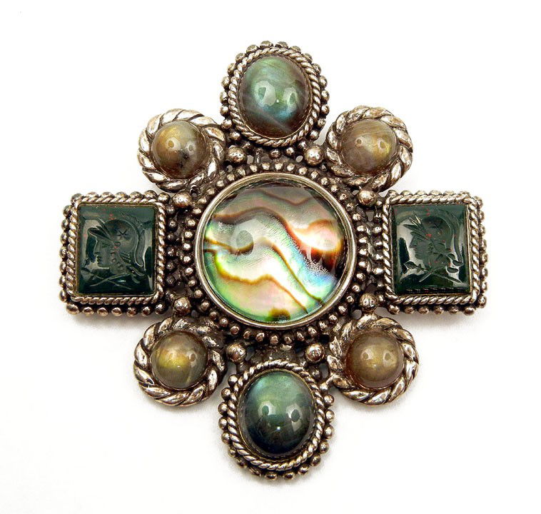 Stephen Dweck sterling silver pin, set with round: Stephen Dweck sterling silver pin, set with round abalone in center under glass, intaglio carved green agate cameos on either side and six oval and round semi-precious stones on top and bottom, 2 1/4"