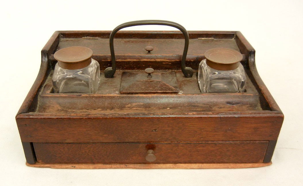 Mahogany desk set, hinged lid on pencil box, doubl: Mahogany desk set, hinged lid on pencil box, double cut glass inkwells with copper lids flank bale handle over paper clip holder with lid, pen well over one long drawer, 5" high x 9" x 6 1/4", early 2