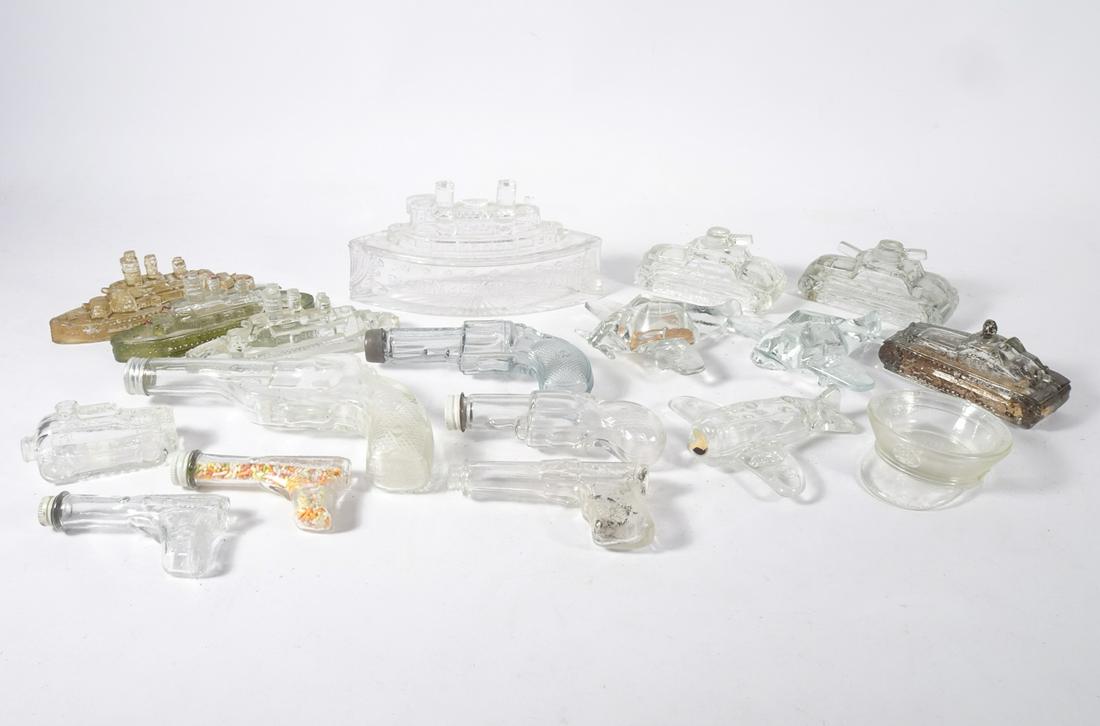 1898-1940's Glass Candy Containers Grouping: Circa 1898-1940's assorted U.S military and gun themed eighteen piece glass candy containers grouping