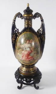 Royal Vienna Austrian Porcelain Urn: Royal Vienna Austrian porcelain urn, cobalt glaze body with hand painted and enamel gilt overlay, front with Wobisch artist signed hand painted allegorical scene depicting a young female seated in a