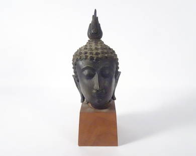 Thai Bronze Sukhothai Style Buddha Head: Thai bronze Sukhothai style Buddha head, circa mid 19th c. to early 20th c., 9" (h) x 4" x 5", comes mounted on a 5" (h) x 3 1/2" x 3 1/2" wood base