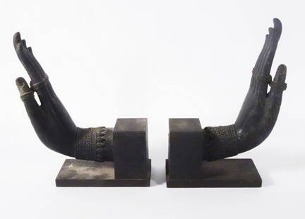 Pair of Thai Bronze Buddha Hands: Pair of Thai bronze Buddha hands with Abhaya Mudra gestures, both are mounted onto L-shaped wood bases, circa mid 19th c. to late 19th c., 9 1/2" (h) x 3" x 5 1/2"