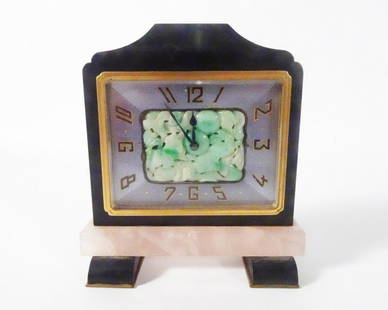 Grogan Company Art Deco Desk Clock: Grogan Company Art Deco 8 Days desk clock, black slate case and feet, engine turned enameled metal clock face with Arabic numerals, centered on the clock face is a carved green Jade mount, beneath the