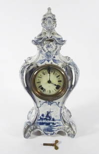 Royal Bonn Delft Case Mantle Clock: Royal Bonn German pottery mantle clock, Ansonia Clock Co. movement, decorated with blue and white Dutch Delft designs, porcelain enamel clock face with Roman Numerals, clock face is signed Manufacture