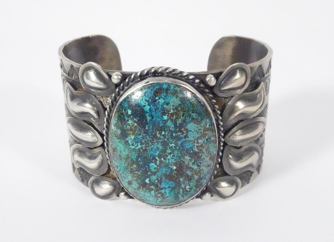 Sterling Turquoise Cuff: Sterling Turquoise Cuff; Weight: 128.0gr.; Width: 50-40mm; bezel set black matrix blue green turquoise central w/applied stamped sun flames and carved cuff w/patina; Stamped: RJ Sterling (Robert Johns