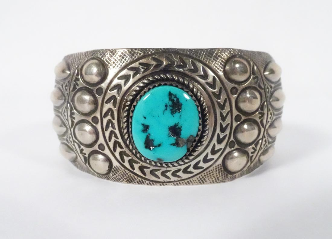 Sterling Repose Sterling Cuff: Sterling Repose Cuff: Weight: 43.3gr; Width: 33mm; Center oval turquoise 20x15mm; Stamped: Sterling WB (Wilbert Benally, Navajo)