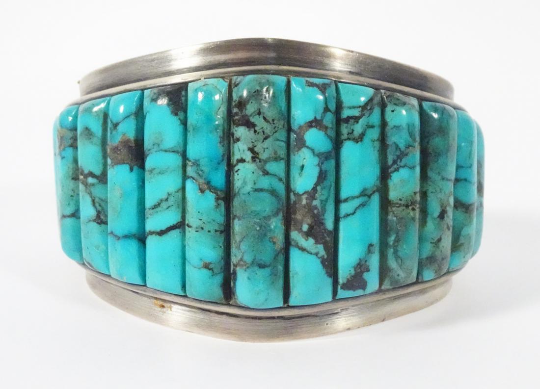 Sterling Turquoise Inlaid Cuff: Sterling Turquoise Inlaid Cuff; Weight:127.5gr; Width: 50-30mm;Stamped: (Tree Symbol, Harry Bert, Navajo) Graduated inlaid bars of turquoise across top with sterling knife edge border.