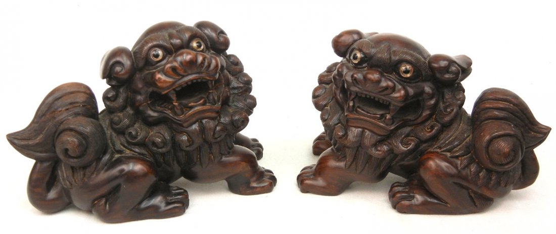 Pair of Rosewood foo dogs, glass eyes, artist sign: Pair of Rosewood foo dogs, glass eyes, artist signed on bottom, 5 1/4" high