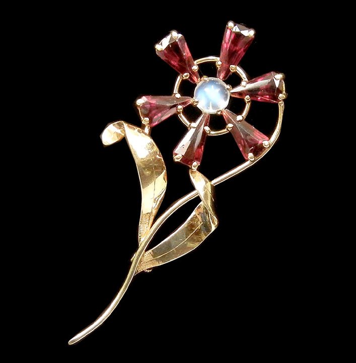 Handmade gold, garnet and moonstone flower pin, 14: Handmade gold, garnet and moonstone flower pin, 14k yellow gold pin set with six triangular shaped almandine garnets with round moonstone in center, 2 1/2" high, marked 14k on clasp, weight 6.0 grams/