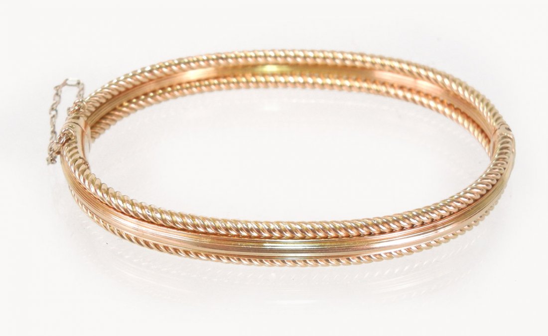 Edwardian gold bangle bracelet, English 15k gold h: Edwardian gold bangle bracelet, English 15k gold hinged bracelet with safety chain, rope turned edge motif with ridged center, 1/4" wide, 6 1/2" inside circumference, marked 15 ct., weight 14.7 grams/