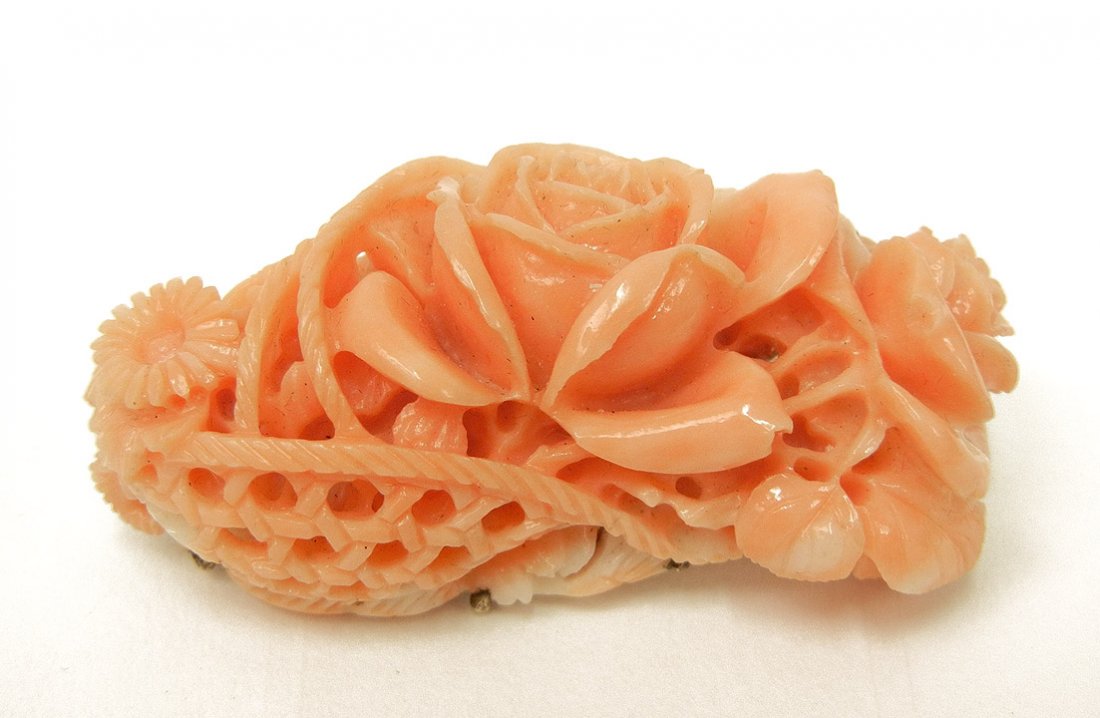 Hand carved coral pin in gold mounting, carved flo: Hand carved coral pin in gold mounting, carved flower and basket motif, 1 5/8" wide, custom made mounting is unmarked, tests 14k, weight 14.0 grams/9.0 dwt, mid 20th C.