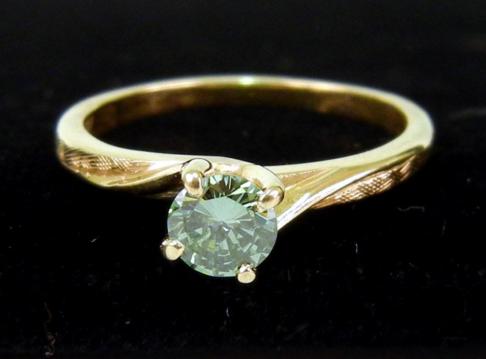 Green diamond solitaire, 14k yellow gold four pron: Green diamond solitaire, 14k yellow gold four prong mounting with round green diamond measuring approximately 35 points, size 5, marked 14k, weight 1.9 grams/1.2 dwt, mid 20th C.