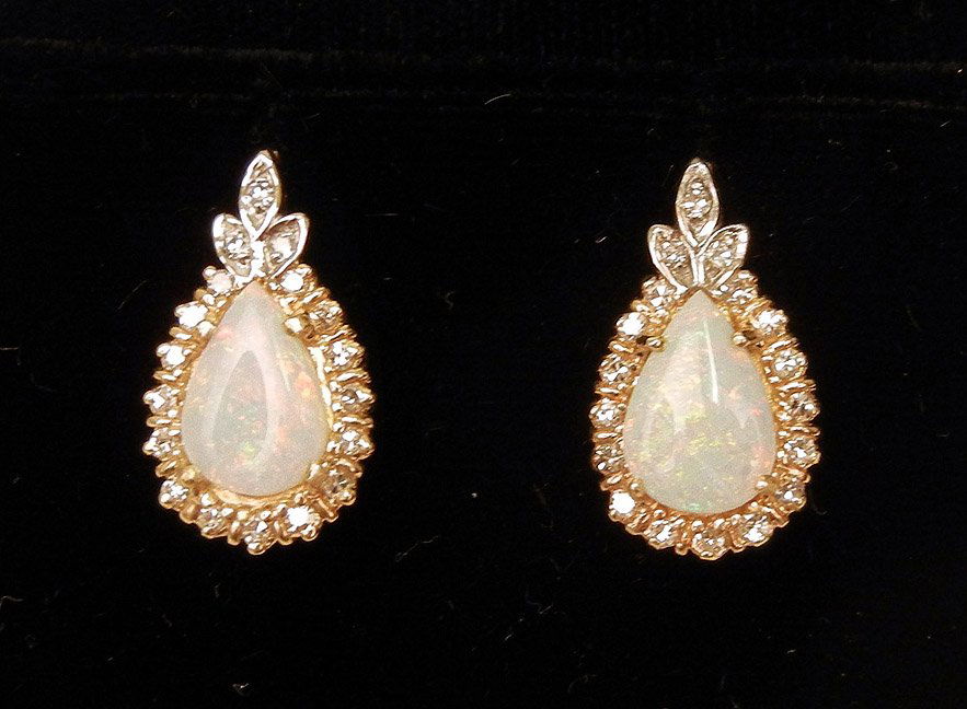 Opal and diamond earrings, 14k yellow gold pierced: Opal and diamond earrings, 14k yellow gold pierced post back earrings, 3/4" long x 7/16" wide, set with pear shaped opal measuring 9mm long x 7mm wide, each surrounded by eighteen round 1 1/2 point di