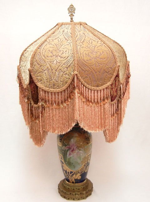 Enameled hand painted table lamp, probably Nippon,: Enameled hand painted table lamp, probably Nippon, cobalt ground, hand painted orchid and gilt decoration, cloth fringed shade, 33 1/2"