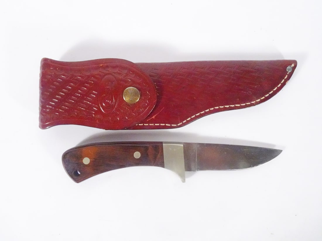 Case XX Arapaho knife: Case XX Arapaho knife. 4" blade. 8 1/2" overall length. 5/8" wide. Wooden handle. Includes brown leather sheath with CASE embossed
