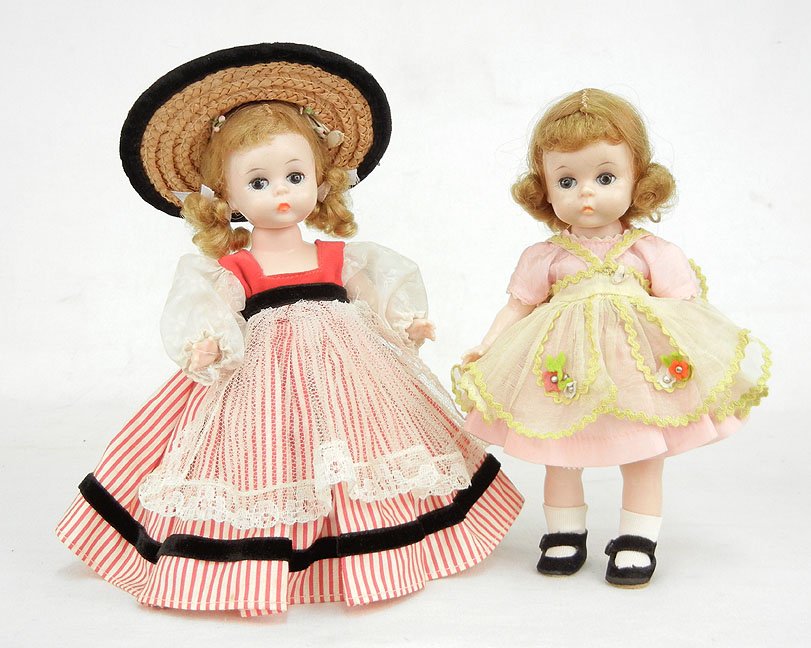 Two dolls, Alexanderkins 8", all original, walker b: Two dolls, Alexanderkins 8", all original, walker body, and "Alex", 8" high, wearing tagged "Vogue Dolls" clothes, both with jointed arms and legs, sleep eyes