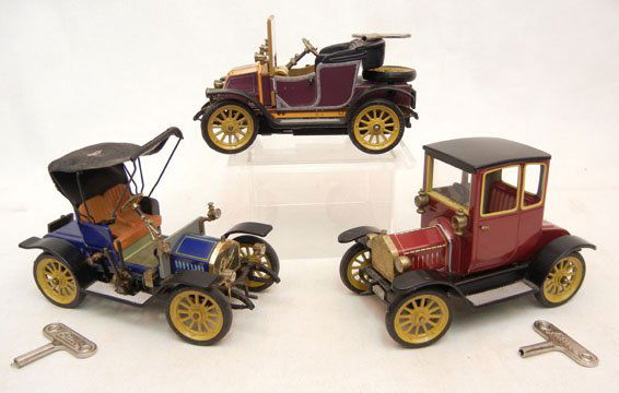 Three Schuco tin lithograph wind up automobiles, i: Three Schuco tin lithograph wind up automobiles, including N 1227 Old Timer Ford Coupe, N 1228 Opel, and N 1230 Old Timer Renault, all three with keys