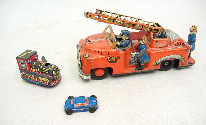 Three Japanese tin toys, including T.N. friction: Three Japanese tin toys, including T.N. friction fire truck, wind, wind up train, and small tin car