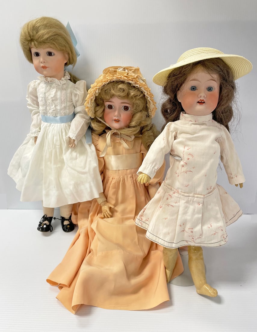 Three bisque head dolls: Three bisque head dolls, 18" Fulper bisque head, glass stationary eyes, open mouth with teeth and tongue compo and wooden body and limbs in newer dress; 24" bisque head marked A.Ws (Adolf Wislizenus)