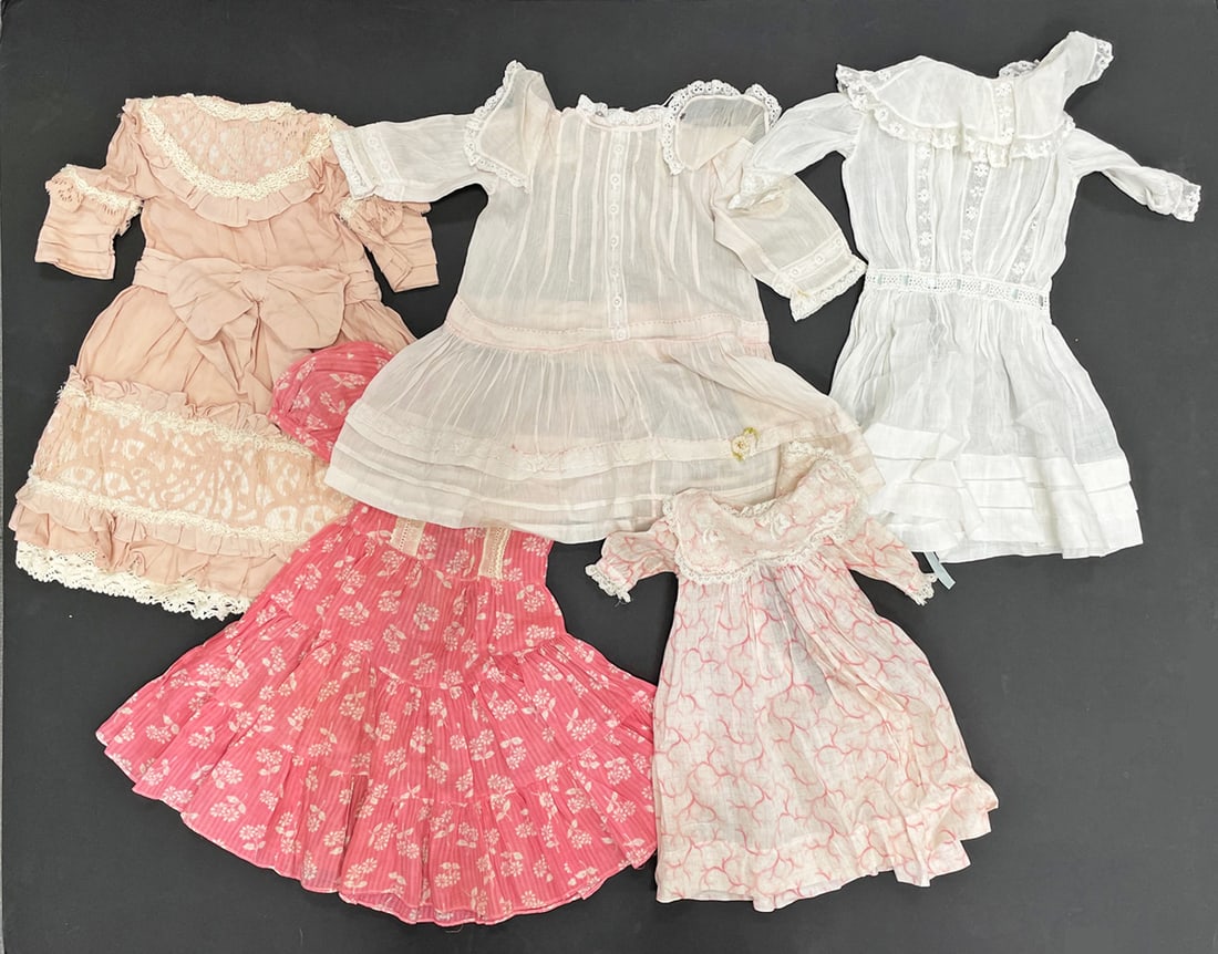 Antique and vintage doll dresses: Antique and vintage doll dresses, various sizes, styles and materials, approximately five pieces, largest 14"