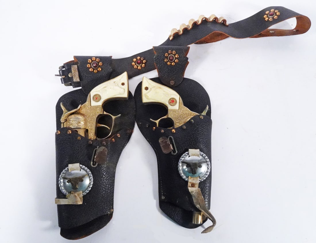 Pair of Hubley Gold Texan Cap Guns: Pair of Hubley Mfg. Co. Gold Texan revolver form cap guns that come with their original holsters, circa 1950's