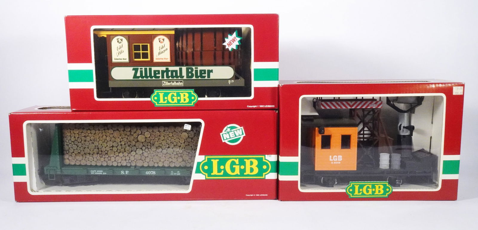 Modern Era LGB Lehmann Trains: Three piece modern era LGB Lehmann G scale trains grouping, #3042 Zillertal Bier Barrel Car, #4049 Operating Searchlight Car and #4078 Southern Pacific Bulkhead Flat Car with Log Load, all come with t