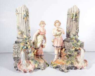 Pair of Continental Majolica Figural Vases: Pair of Continental Majolica pottery figural vases, standing young male playing a Pan flute and standing young female with and urn in her left hand, both are standing next to a cylindrical vase form