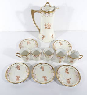 German Porcelain Kewpie Designed Chocolate Set: Eleven piece German porcelain chocolate set, each piece is decorated with hand painted kewpie in different poses and floral designs, circa early 20th c., Chocolate Pot is signed on underside of base