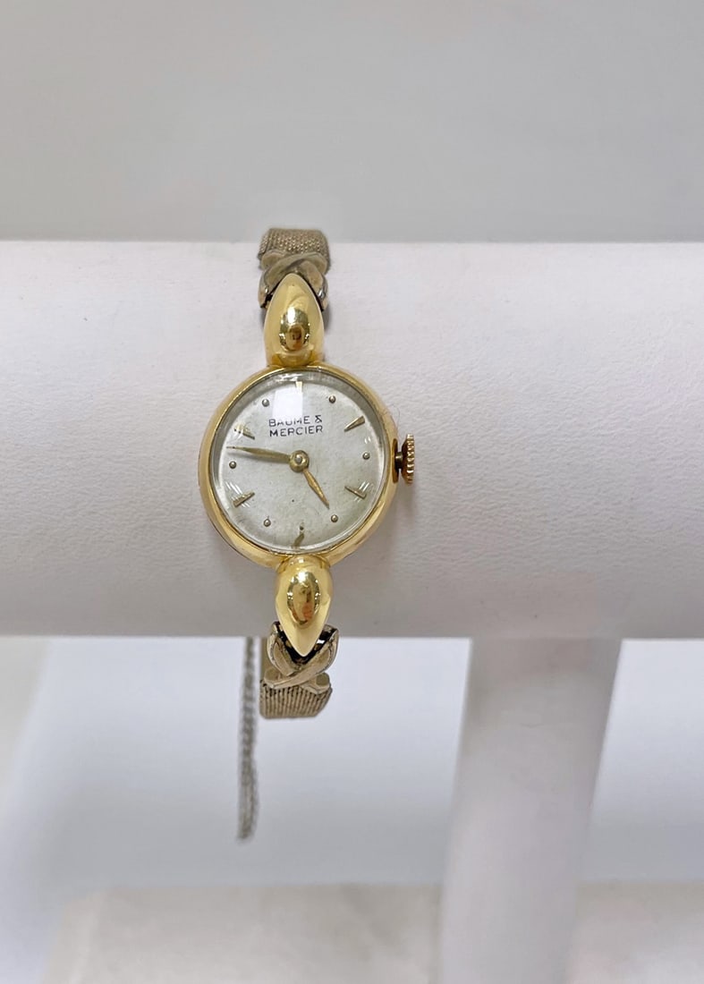 Baume & Mercier 18K Gold Petite Watch: Baume & Mercier 18K gold petite watch; round yellow gold case marked 3602 Stamped 18K 0.750 57217 inside case, holds a mechanical movement white dial w/stick markers; Kreisler gold filled bracelet ban