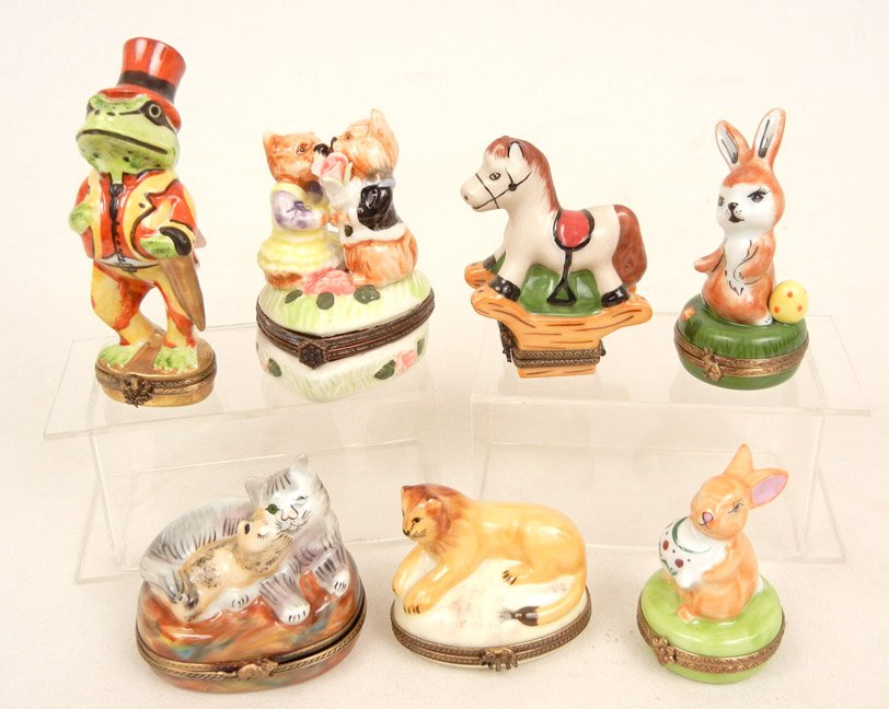Seven Limoges porcelain pill boxes including rockin: Seven Limoges porcelain pill boxes including rocking horse, lion, cat and kitten, rabbit and Easter egg, frog, and limited edition rabbit with teapot, all signed Peint Main Limoges France, and two kis
