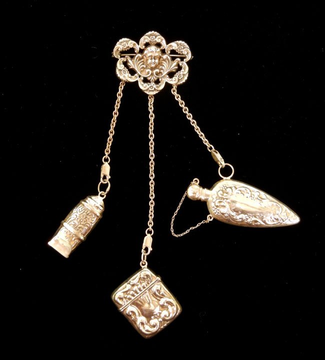 Victorian style sterling silver chatelaine, pin wi: Victorian style sterling silver chatelaine, pin with cherub motif holds whistle, match safe and perfume bottle on chains, 6 1/2" long x 1 5/8" wide, marked sterling 925, weight 50.0 grams, contemporar