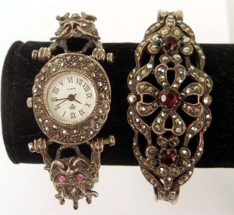 Sterling silver and marcasite bracelet and watch, : Sterling silver and marcasite bracelet and watch, double hinged bangle bracelet, flower motif, 1" wide at center, set with three round garnets and marcasites, inside dimensions are 2 1/4" x 2", marked